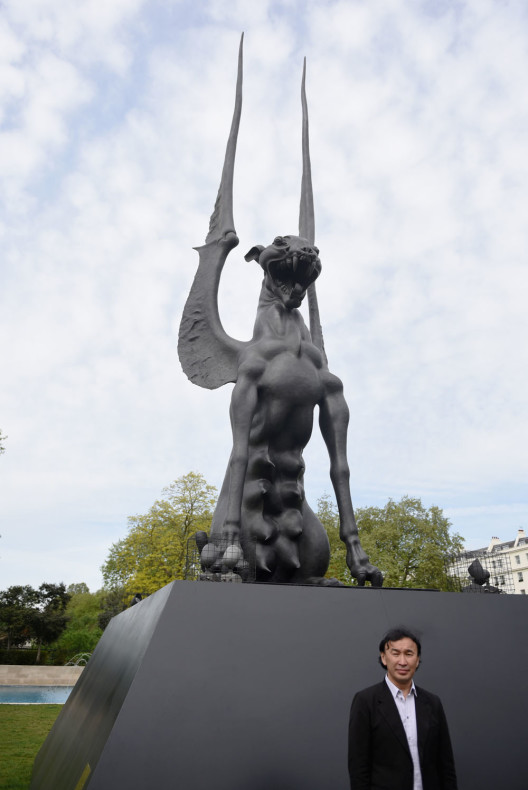 LONDON, ENGLAND - MAY 11:  Artist Dashi Namdakov stands in front of his  monumental bronze sculpture 'She Guardian' at its unveiled by Halcyon Gallery in Marble Arch on May 11, 2015 in London, England. The sculpture is 11 metres high and took the artist over two years to complete, and looks out over London with her protective maternal instict.  (Photo by Mary Turner/Getty Images for Halcyon Gallery)
